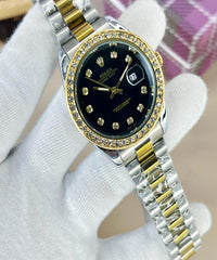 Luxury watch with black face and gold accents on a white glove