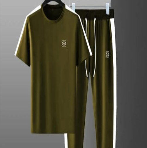 Green tracksuit with white accents on hangers against a gray background