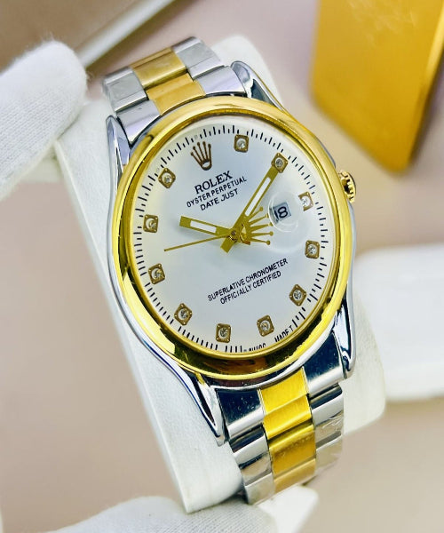Gold and silver watch with diamond-studded face on a white background