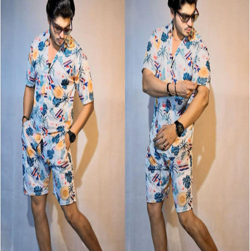 Man wearing a colorful floral outfit against a plain background