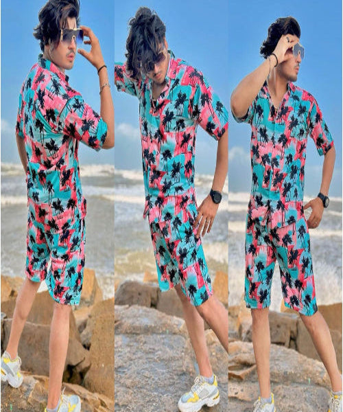 Person wearing a colorful outfit with palm tree pattern on a beach