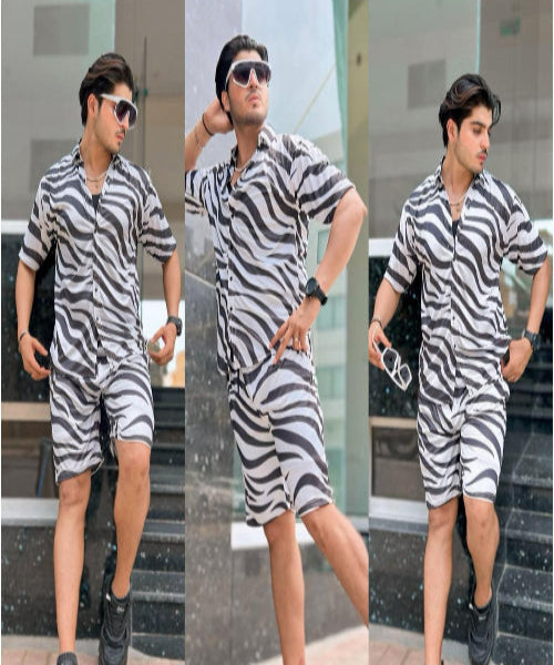 Man wearing a zebra print outfit with black shoes in three different poses.