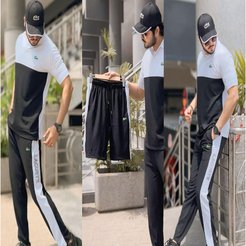 Man modeling black and white outfit with brand logo outdoors.