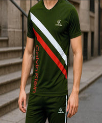 Person wearing a green Calvin Klein outfit with red and white accents on a city street.