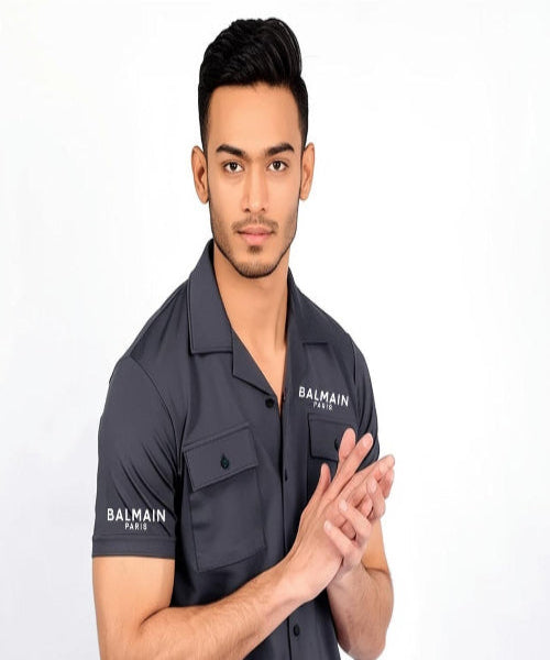 Man wearing a Balmain shirt on a white background