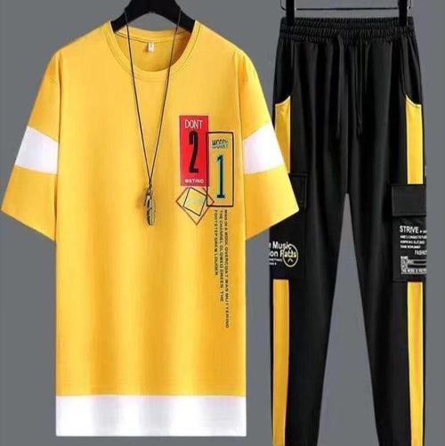 Yellow t-shirt and black pants with text and graphics on a gray background