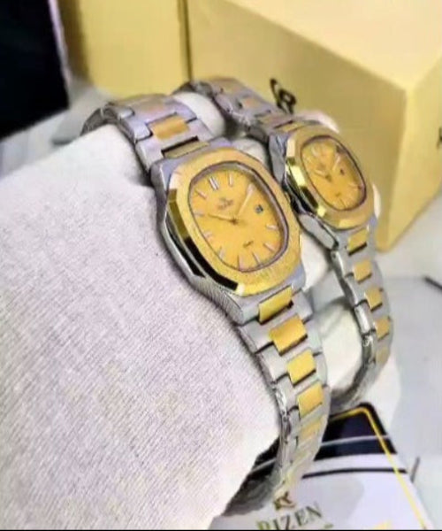 Pair of silver and gold watches on a white surface with 'RIZEN' branding.