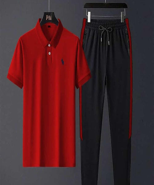 Red polo shirt and black pants with red accents on hangers against a dark background